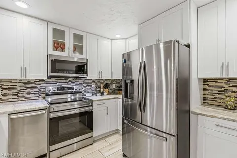 a kitchen with stainless steel appliances a refrigerator stove and microwave