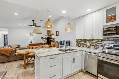 a kitchen with a sink stove and cabinets
