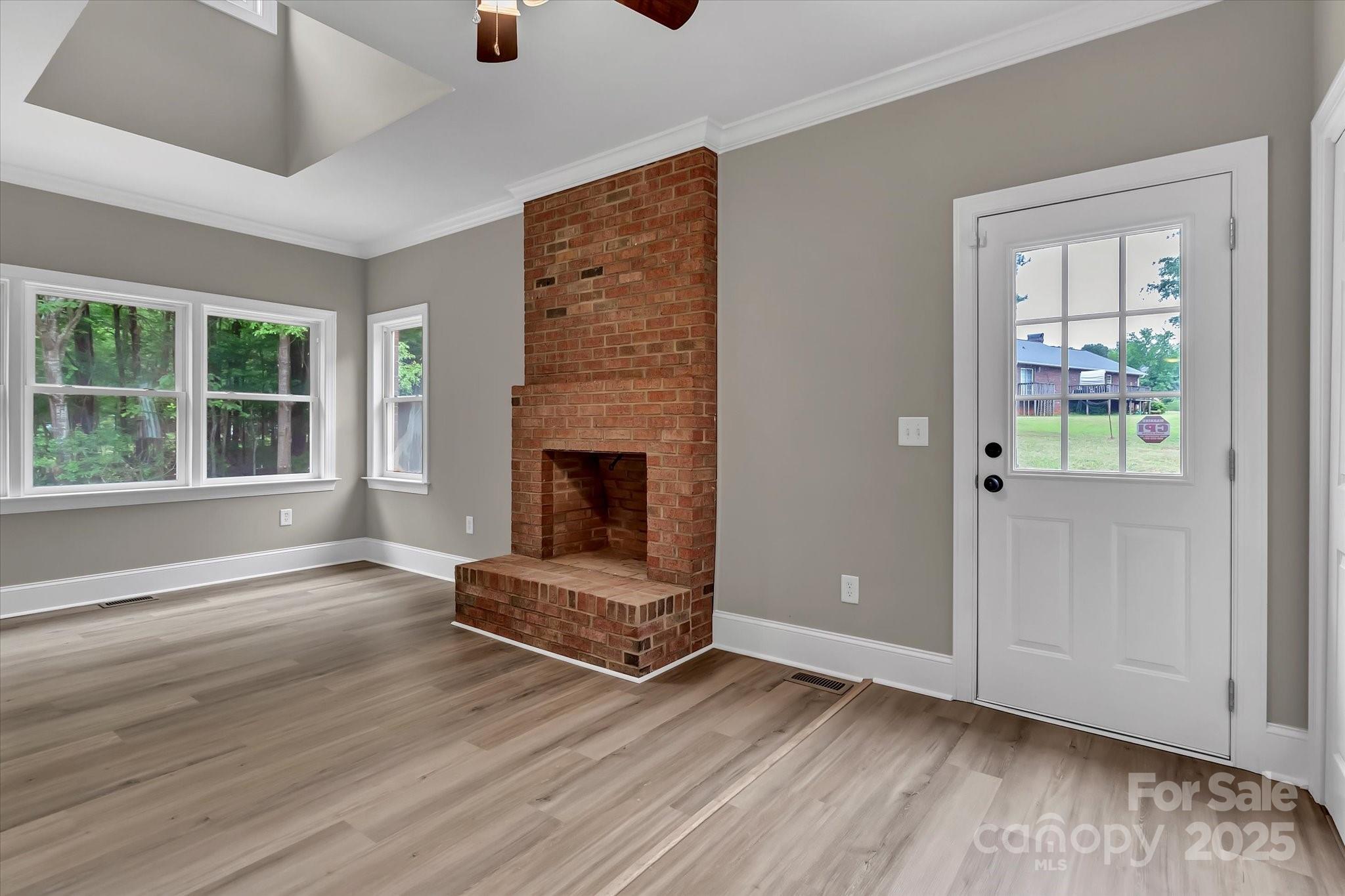 332 East Rebound Road Lancaster, SC 29720 - Photo 12 of 29 an empty room with wooden floor fireplace and windows