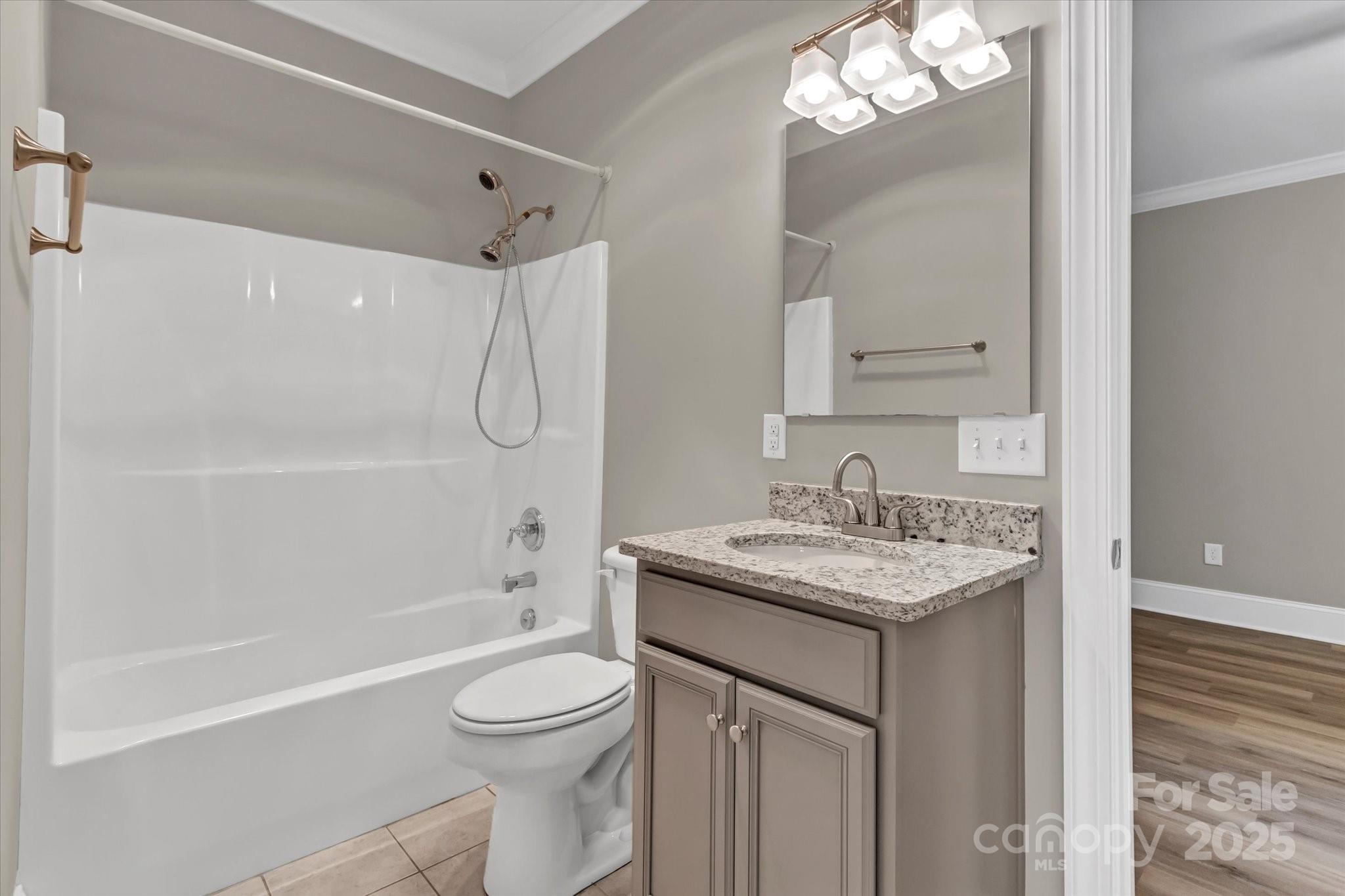 332 East Rebound Road Lancaster, SC 29720 - Photo 14 of 29 a bathroom with a granite countertop sink a toilet and shower