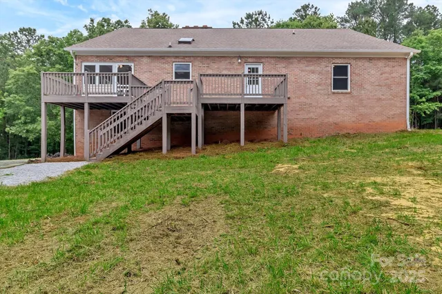 a aerial view of a house with a yard and deck
