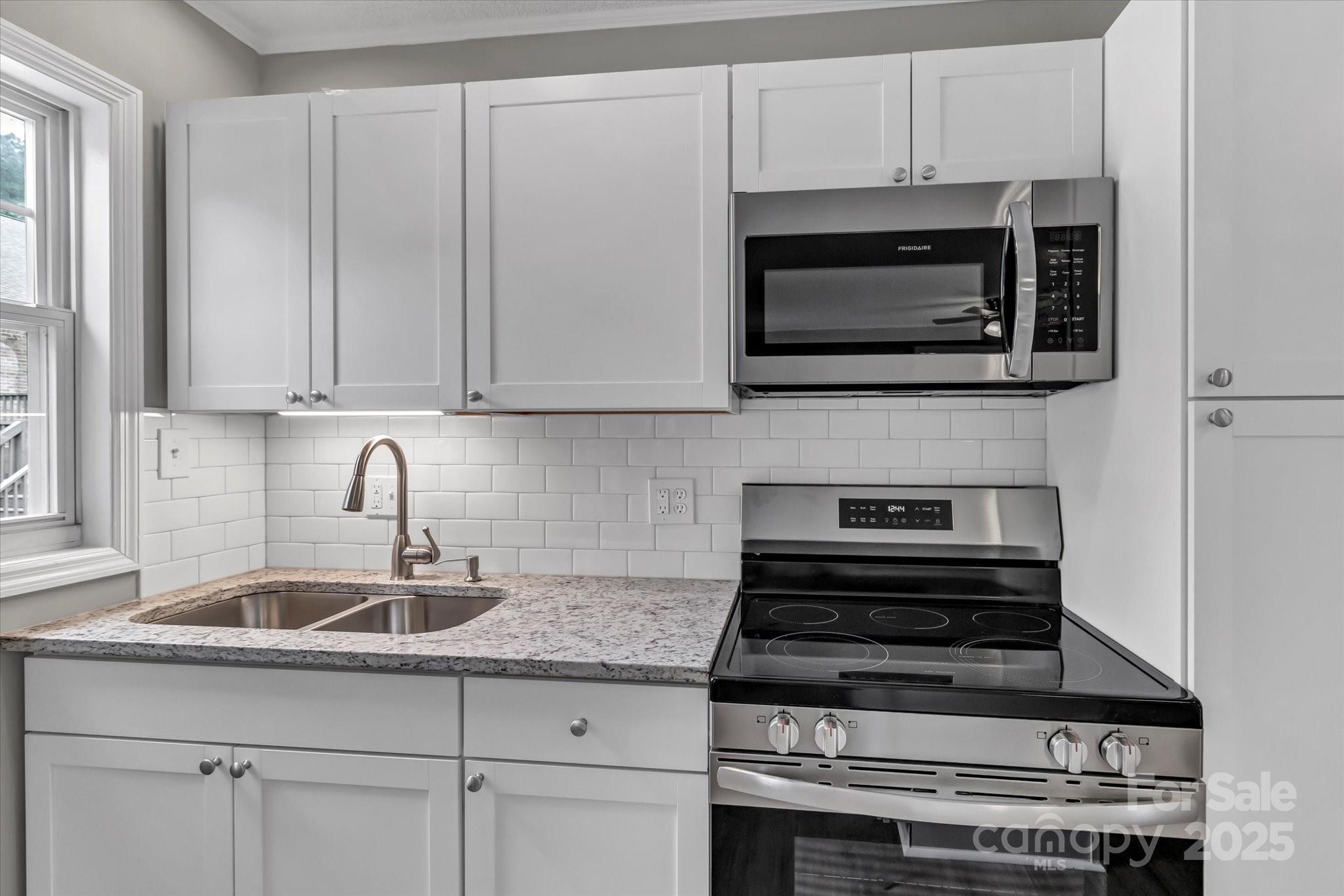 332 East Rebound Road Lancaster, SC 29720 - Photo 23 of 29 a kitchen with granite countertop a stove and a sink
