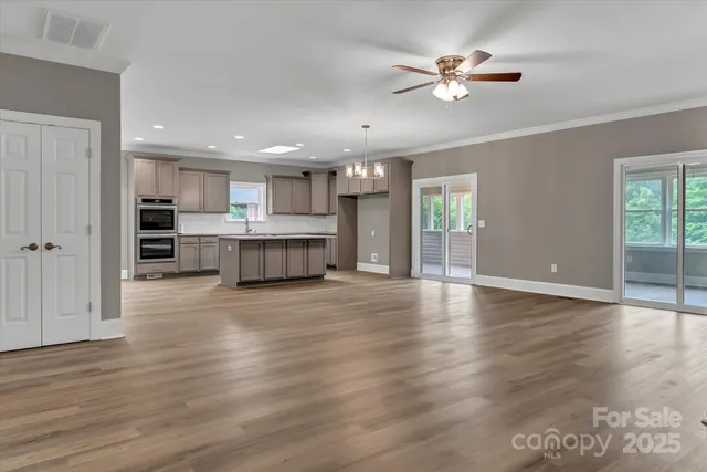 a kitchen with granite countertop a sink and a stove