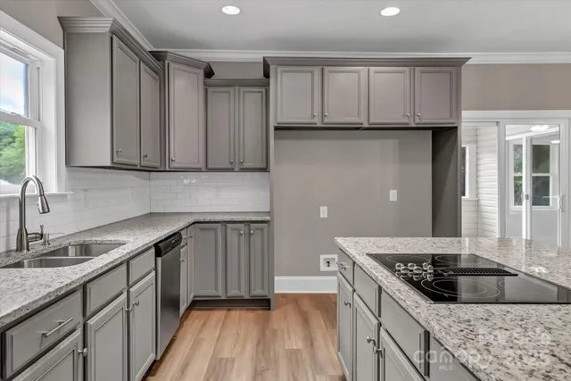 a view of empty room with wooden floor and fireplace