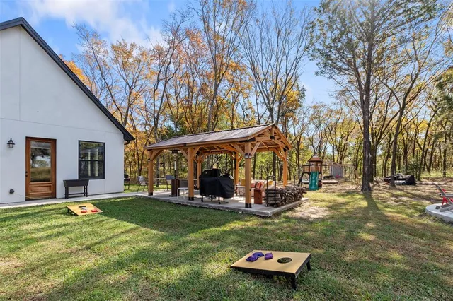 a view of dirt yard with a tree
