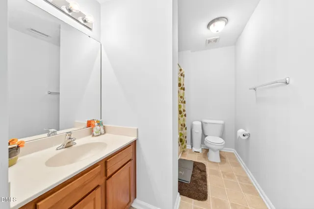 a bathroom with a sink toilet and a mirror
