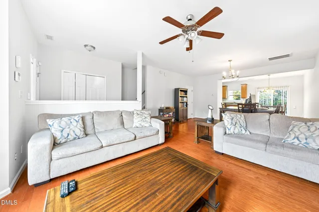 a living room with furniture and kitchen view