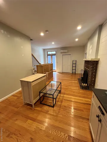 a living room with furniture gym equipment and a table