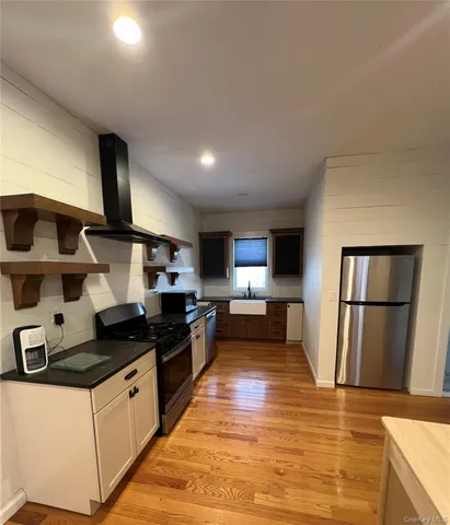 a kitchen with granite countertop a refrigerator stove and microwave