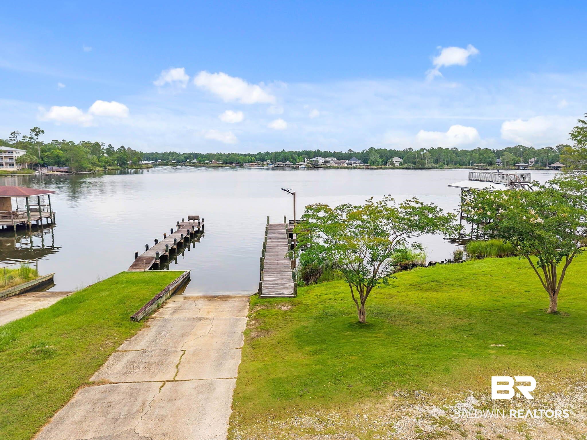 8145 Bay View Drive Foley, AL 36535 - Photo 74 of 81 Dock area featuring a water view, a boat ramp, and a yard