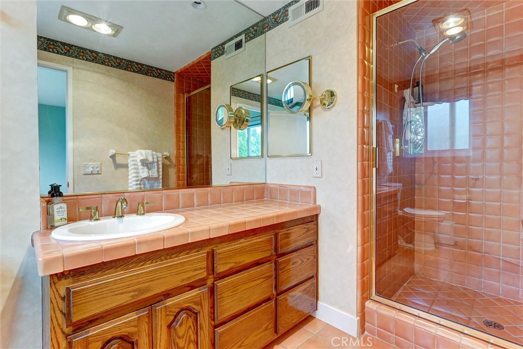 19238 Castlebay Lane Porter Ranch, CA 91326 - Photo 21 of 38 a bathroom with a granite countertop sink and a mirror