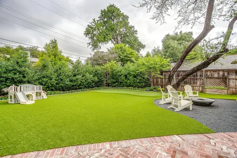 a view of a swimming pool with lawn chairs under an umbrella