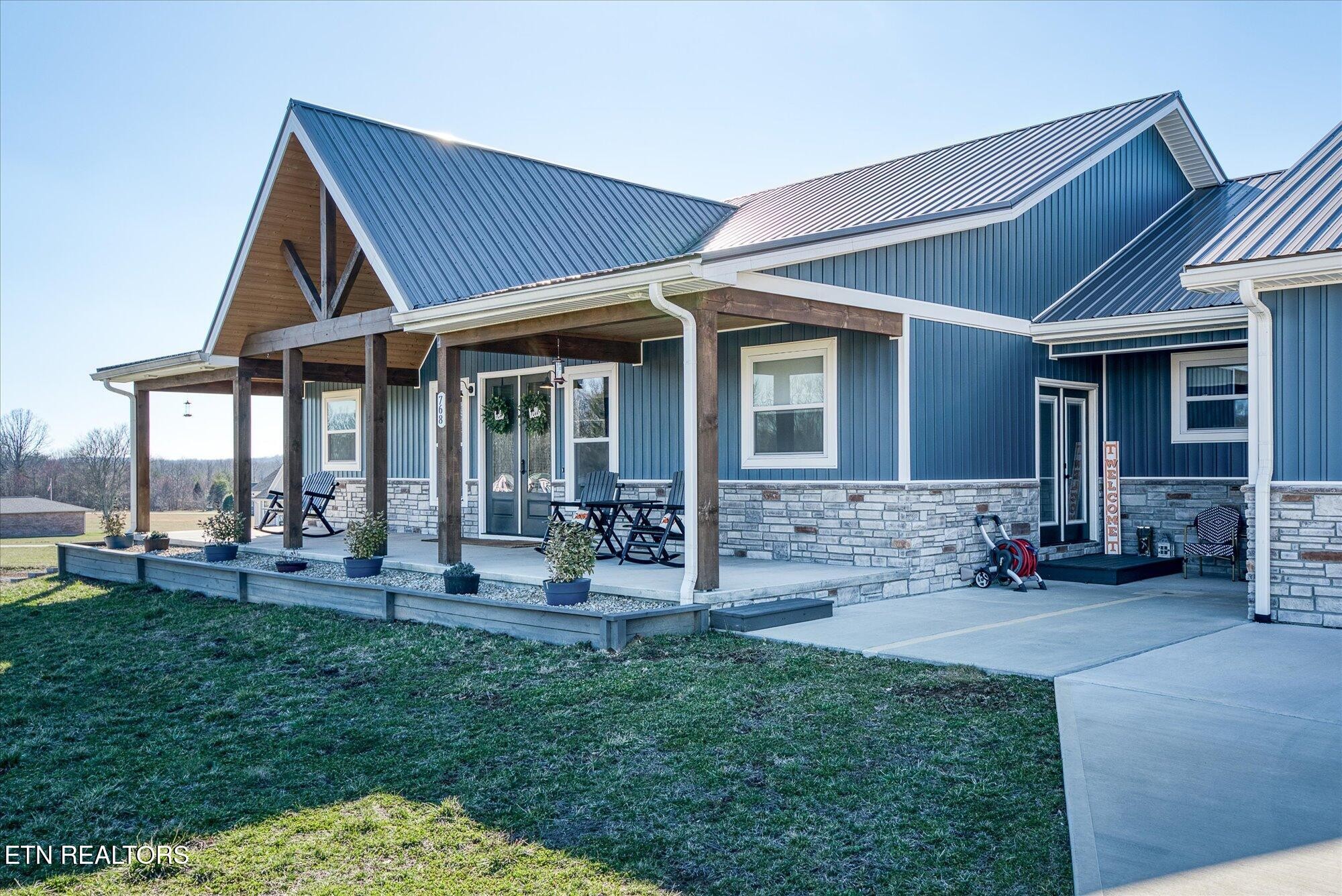 768 Winningham Road Crossville, TN 38572 - Photo 3 of 54 a front view of a house with patio and garden