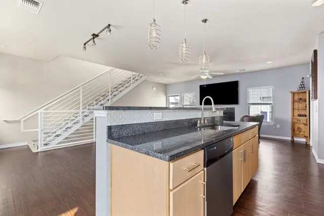 a large kitchen with stainless steel appliances granite countertop a stove and a sink
