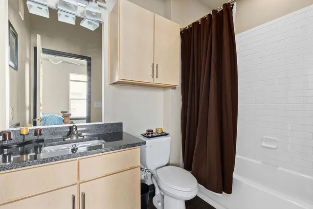 a view of walk in closet with clothes