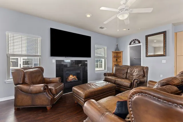 a living room with furniture fireplace and flat screen tv