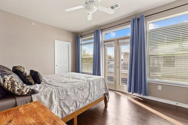 a bedroom with bed and balcony with furniture