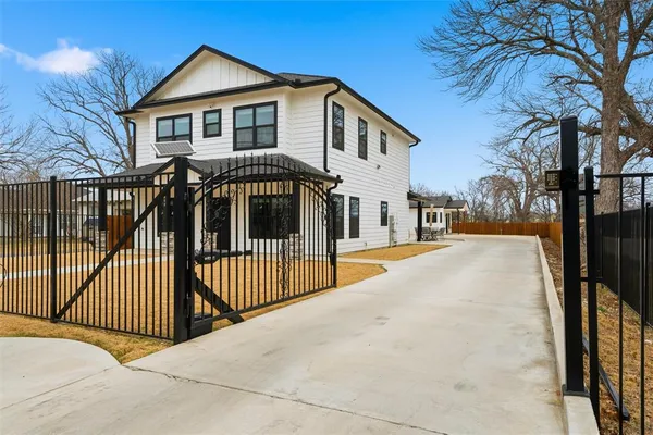 a view of a house with wooden fence