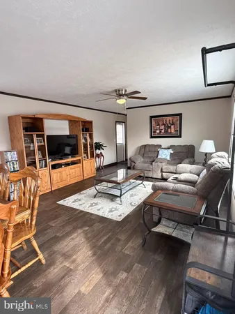 a living room with furniture a rug and a flat screen tv