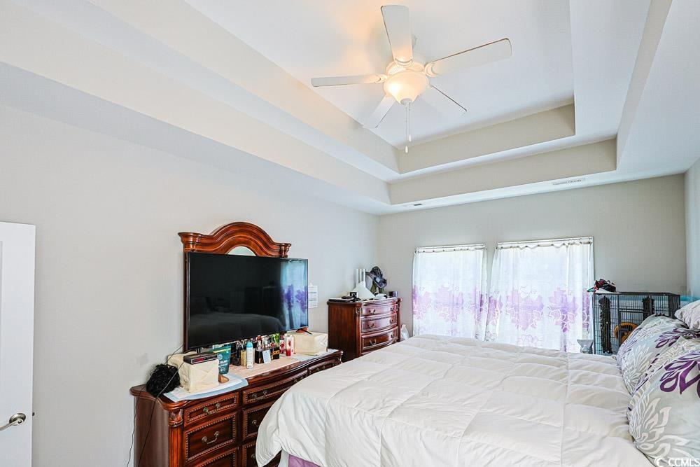 724 Hobonny Loop Longs, SC 29568 - Photo 13 of 40 Bedroom with a raised ceiling and a ceiling fan