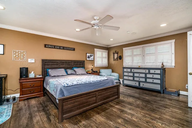 a view of a livingroom with wooden floor and windows