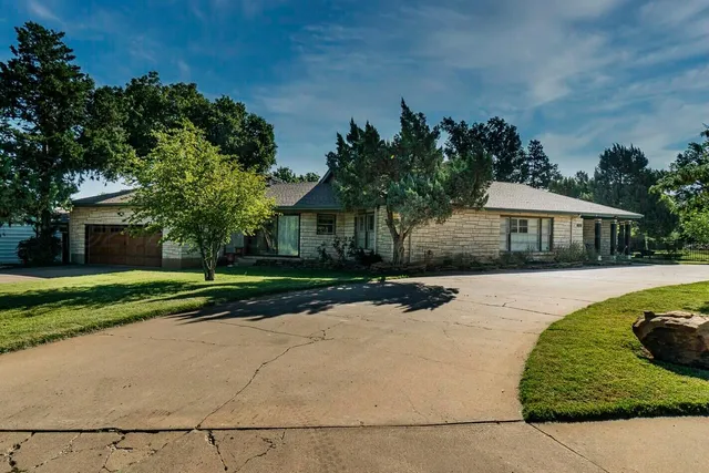 an aerial view of a house with yard swimming pool and outdoor seating