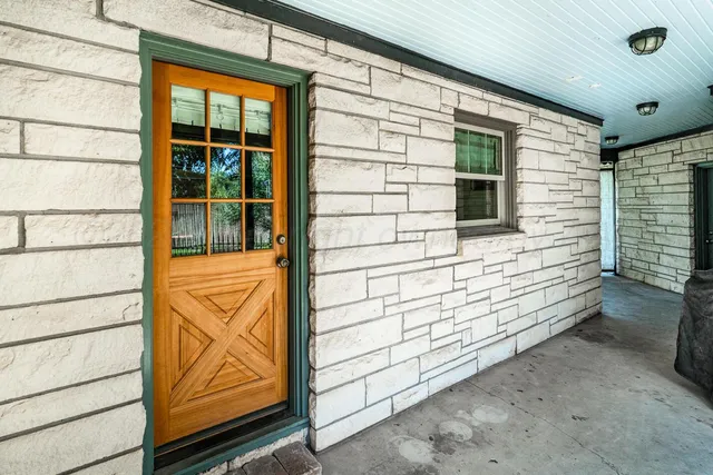 an aerial view of a house with a yard and lake view