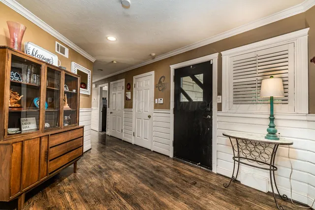 a front view of a house with a yard and trees