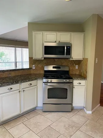 a kitchen with a stove a sink and a refrigerator