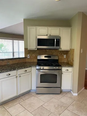 a kitchen with a stove a sink and a refrigerator
