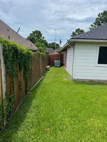 a view of a backyard with large trees