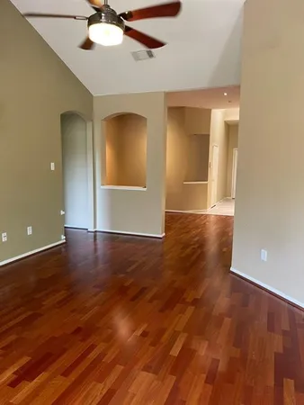 a view of a living room with hardwood floor and a kitchen