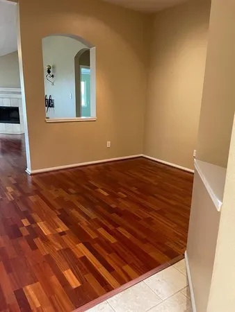 a view of a room with wooden floor and a window