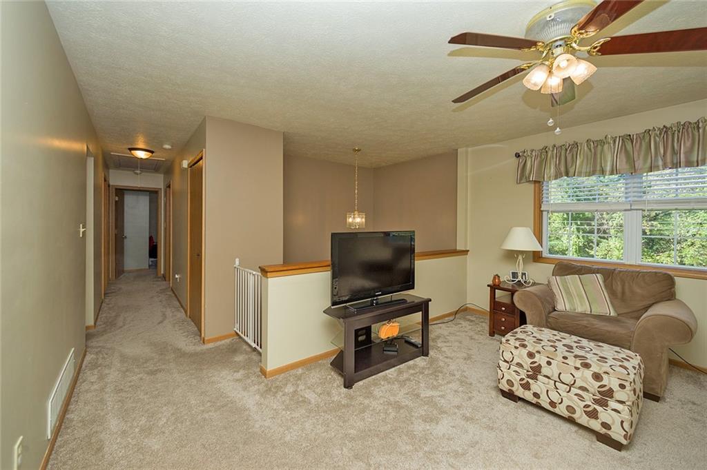 7326 Ringertown Road Export, PA 15632 - Photo 11 of 25 a living room with furniture and a flat screen tv