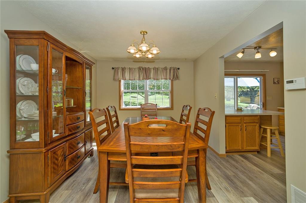 7326 Ringertown Road Export, PA 15632 - Photo 12 of 25 a dining room with furniture a chandelier and wooden floor
