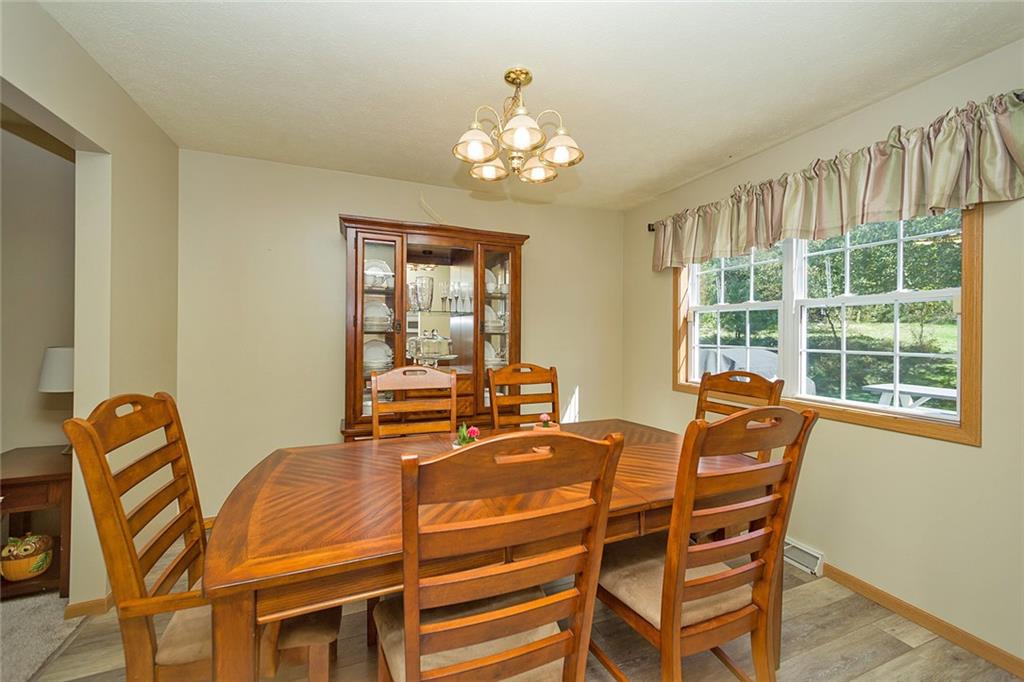 7326 Ringertown Road Export, PA 15632 - Photo 13 of 25 a dining room with chandelier and wooden floor