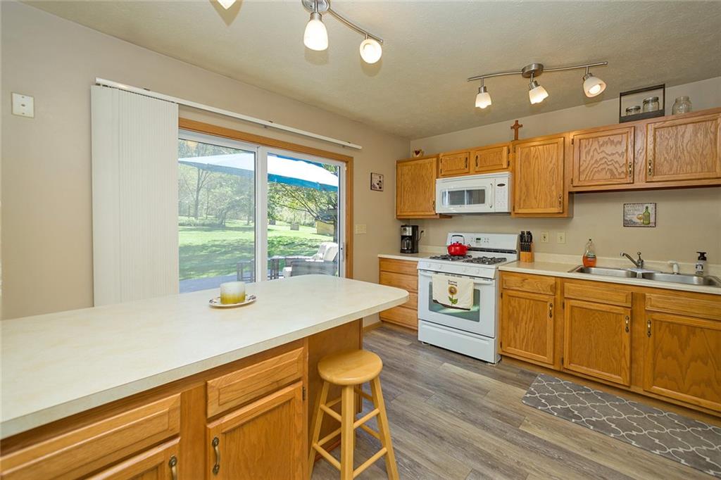7326 Ringertown Road Export, PA 15632 - Photo 14 of 25 a kitchen with a stove a sink and a refrigerator