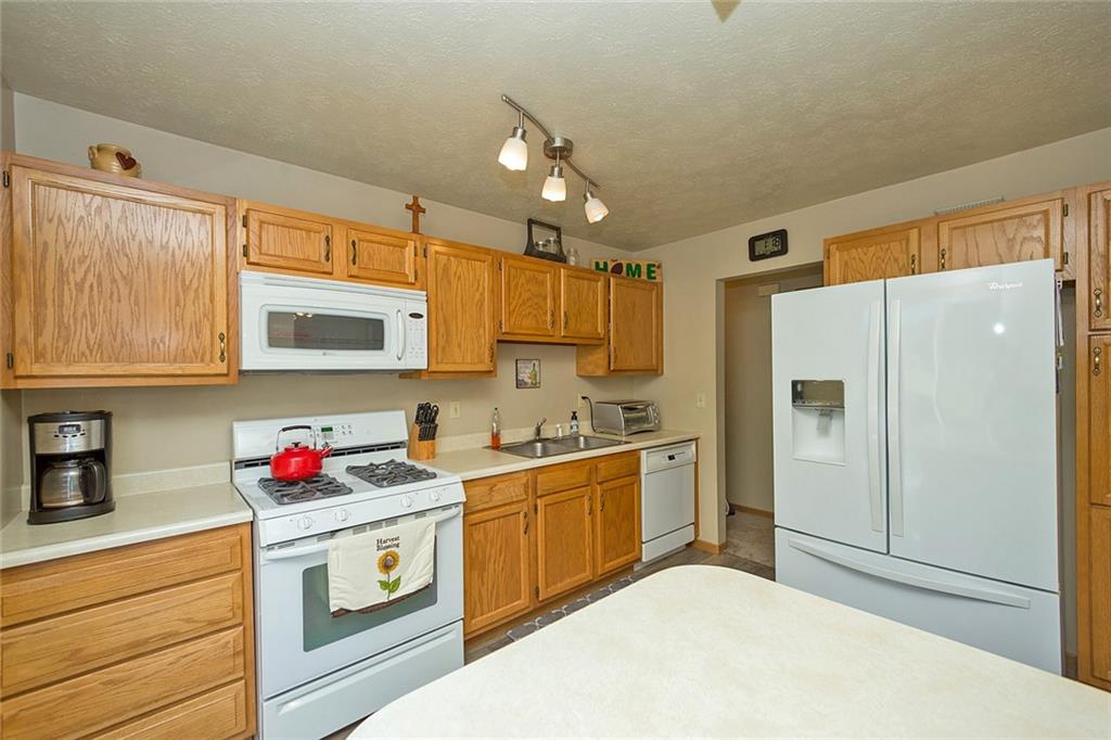 7326 Ringertown Road Export, PA 15632 - Photo 15 of 25 a kitchen with stainless steel appliances granite countertop a refrigerator sink and cabinets