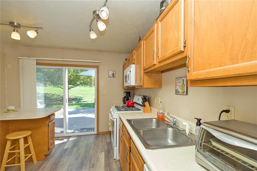 7326 Ringertown Road Export, PA 15632 - Photo 17 of 25 a kitchen with stainless steel appliances granite countertop a sink stove and cabinets