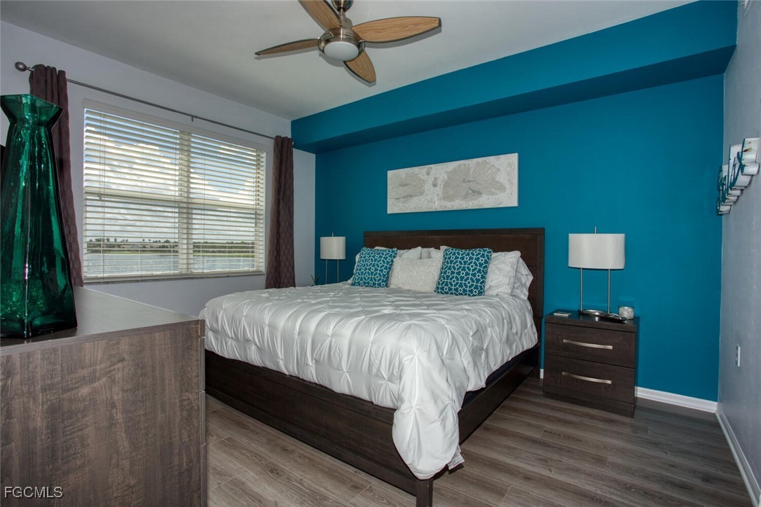 10371 Butterfly Palm Drive, Unit 834 Fort Myers, FL 33966 - Photo 11 of 22 a bed sitting in a bedroom next to a window