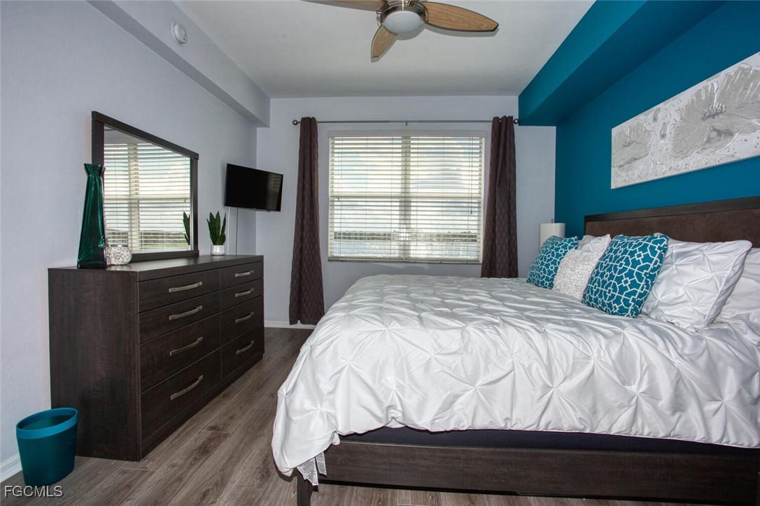 10371 Butterfly Palm Drive, Unit 834 Fort Myers, FL 33966 - Photo 12 of 22 a bedroom with a bed and a flat screen tv