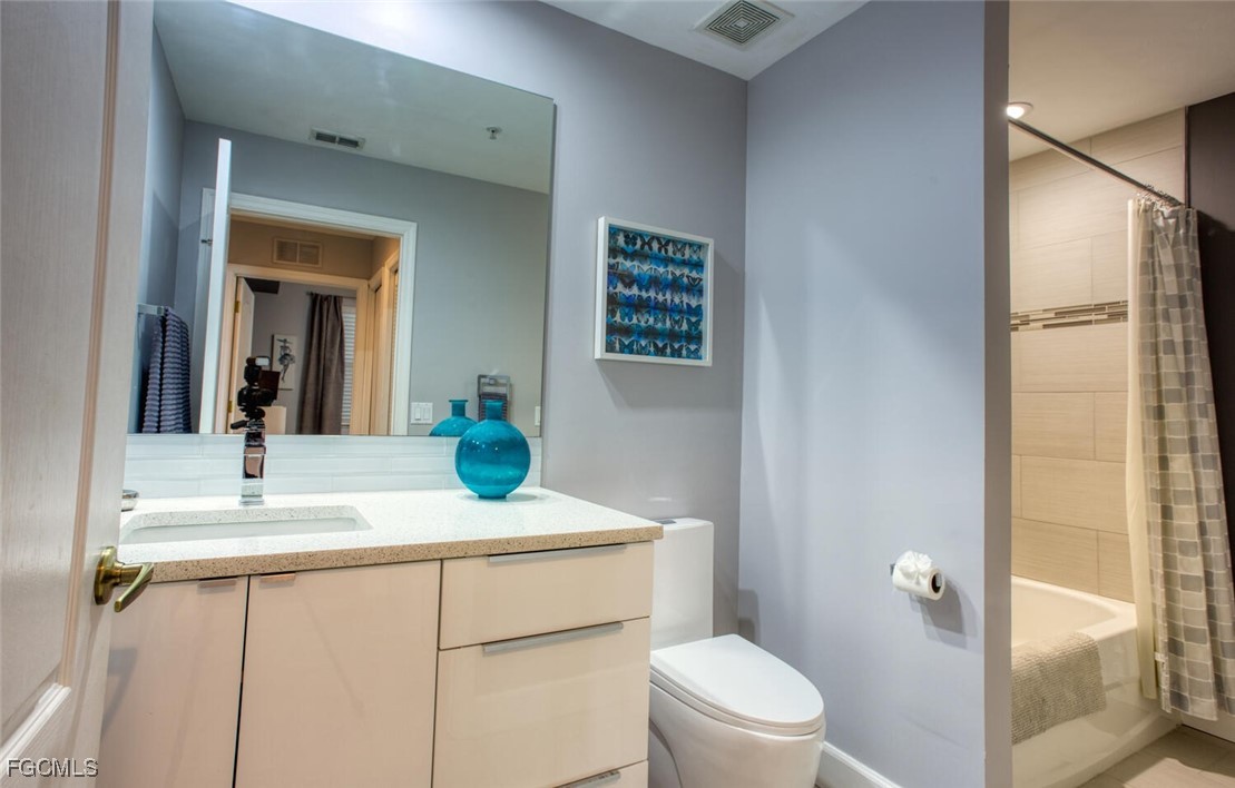 10371 Butterfly Palm Drive, Unit 834 Fort Myers, FL 33966 - Photo 15 of 22 a bathroom with a sink a toilet and shower