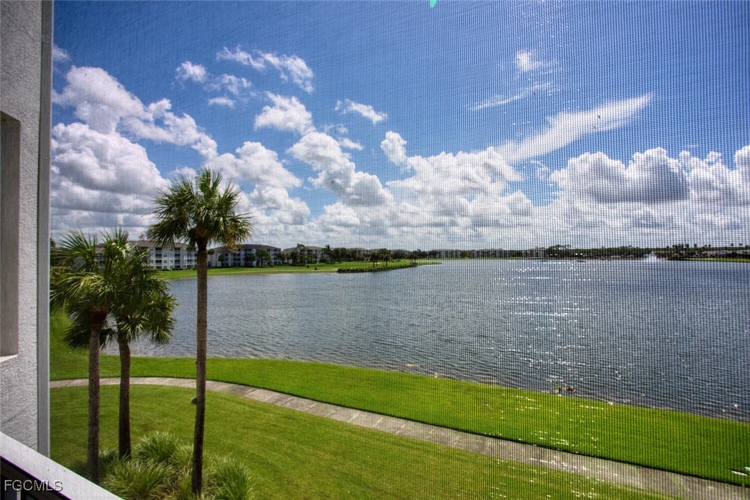 10371 Butterfly Palm Drive, Unit 834 Fort Myers, FL 33966 - Photo 2 of 22 a view of a lake from a yard