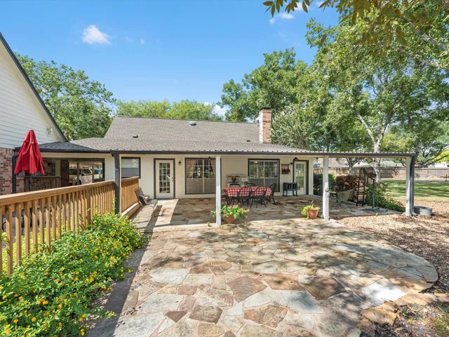 a view of a house with sitting area and garden