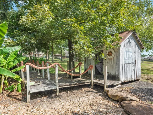 a wooden bench sitting in front of a house