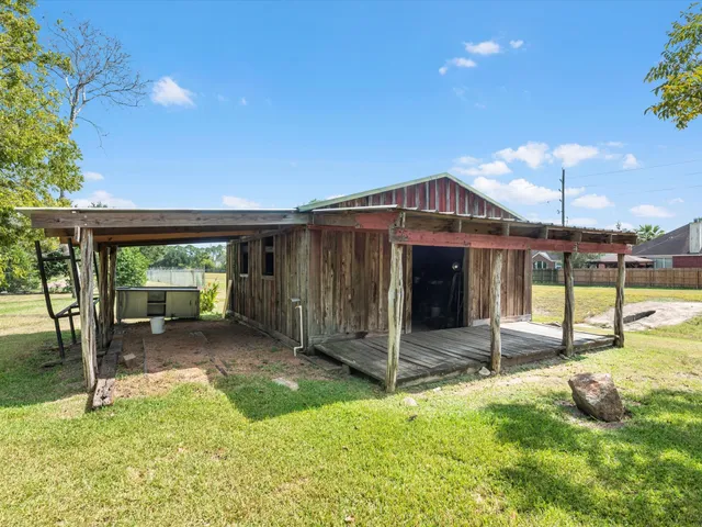 a view of a house with backyard porch and sitting area