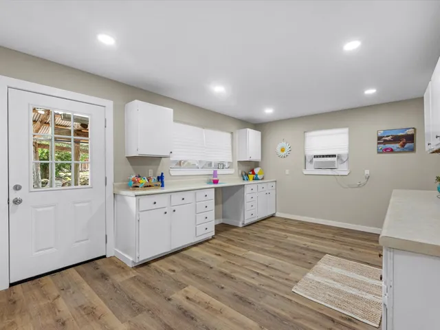 a kitchen with granite countertop cabinets stainless steel appliances a sink and a window