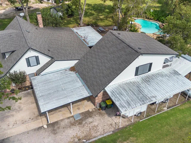an aerial view of a house with garden space and sitting area