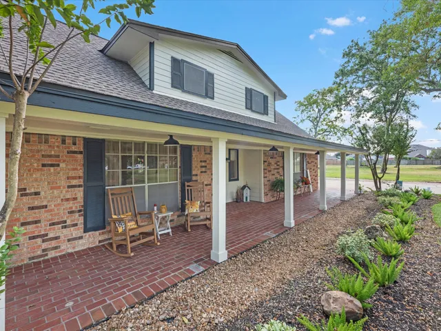 a view of a house with backyard porch and sitting area