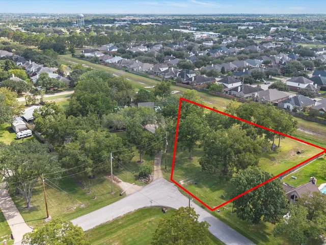 an aerial view of residential houses with outdoor space and swimming pool